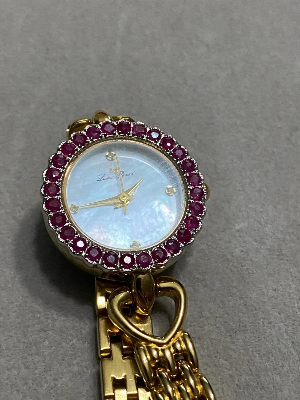 Lucien Piccard Gold-Tone Watch with Ruby Stone Bezel